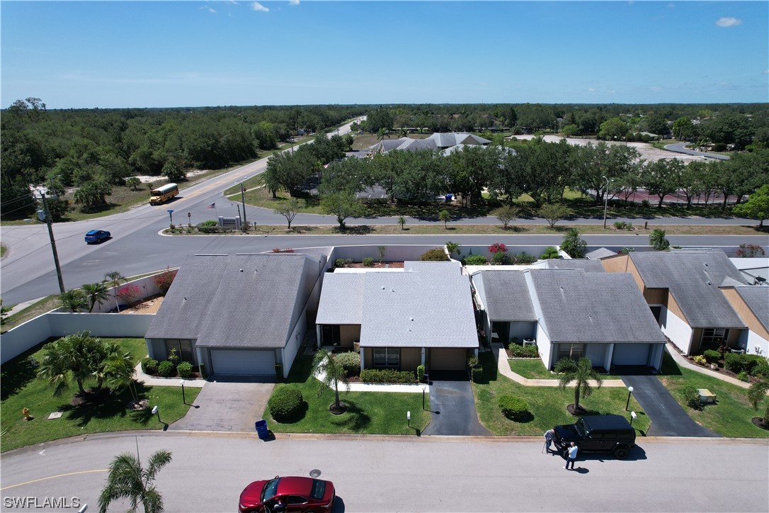 9805 Maplecrest Circle Lehigh Acres, FL 33936 - Photo 10 of 38 an aerial view of a house with a garden