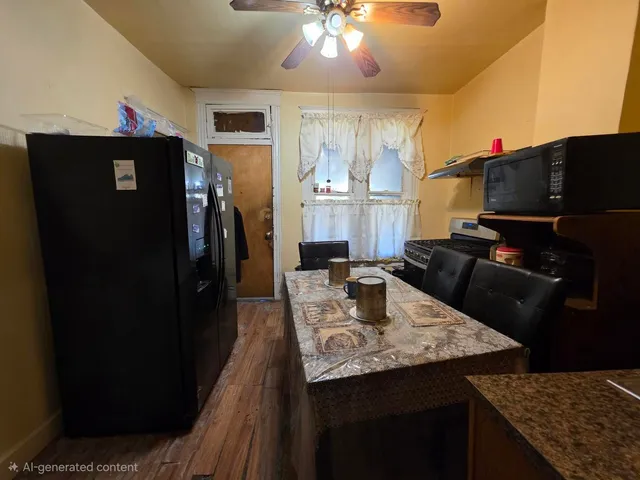 a living room with granite countertop furniture a fireplace and kitchen view