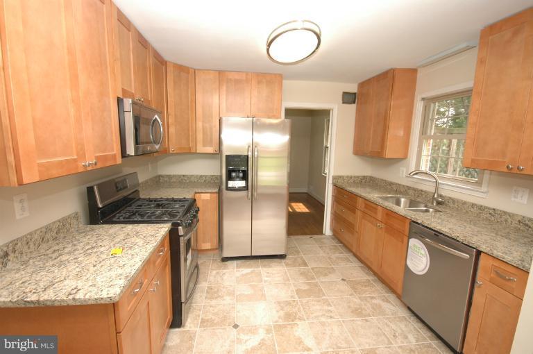 13207 Tamarack Road Silver Spring, MD 20904 - Photo 1 of 24 a kitchen with stainless steel appliances granite countertop a sink stove and refrigerator
