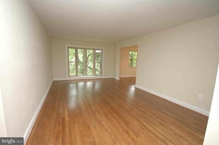 13207 Tamarack Road Silver Spring, MD 20904 - Photo 2 of 24 an empty room with wooden floor and windows