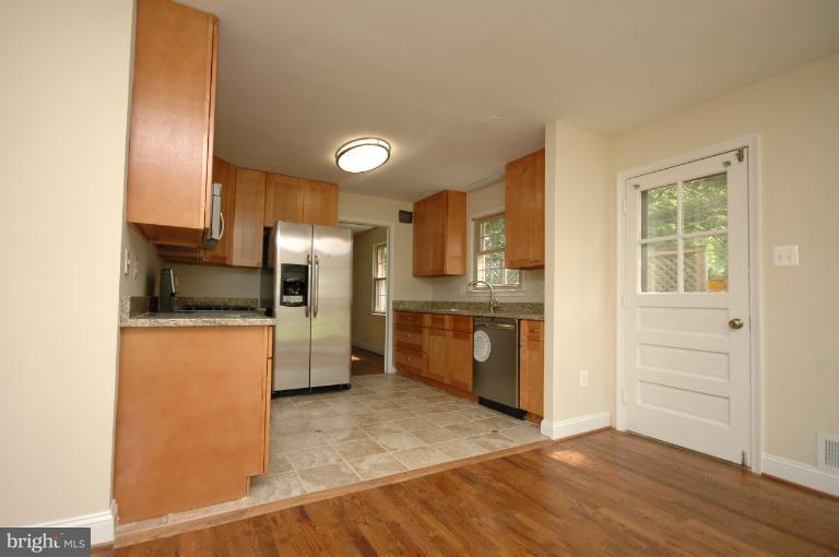 13207 Tamarack Road Silver Spring, MD 20904 - Photo 11 of 24 a kitchen with granite countertop a refrigerator and a sink