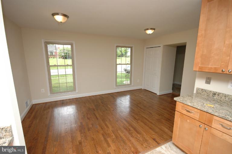 13207 Tamarack Road Silver Spring, MD 20904 - Photo 12 of 24 a view of an empty room with wooden floor and a window