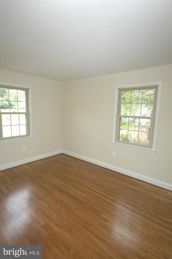 13207 Tamarack Road Silver Spring, MD 20904 - Photo 18 of 24 an empty room with wooden floor and windows