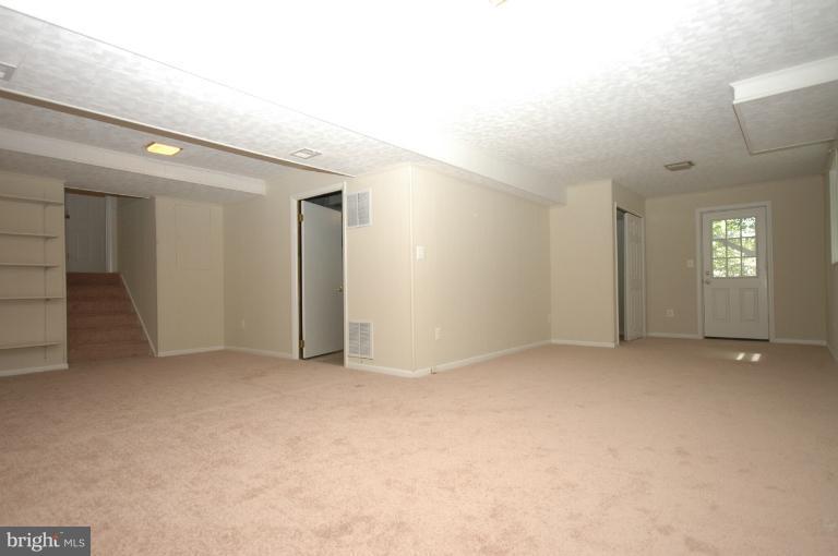 13207 Tamarack Road Silver Spring, MD 20904 - Photo 19 of 24 an empty room with windows and entrance