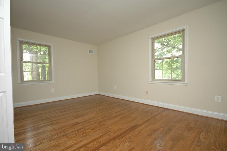13207 Tamarack Road Silver Spring, MD 20904 - Photo 20 of 24 a view of an empty room with wooden floor and a window