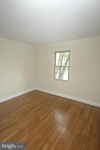 13207 Tamarack Road Silver Spring, MD 20904 - Photo 8 of 24 an empty room with wooden floor and windows