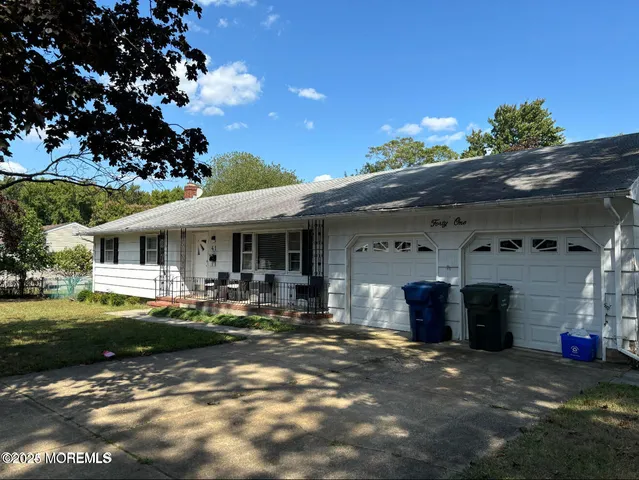 a front view of a house with sitting area and garden