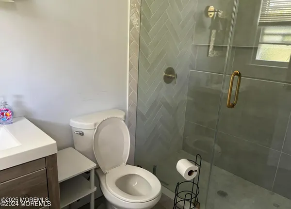 a white toilet sitting next to a bathroom sink