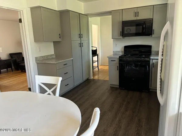 a kitchen with stainless steel appliances a stove a microwave and a refrigerator