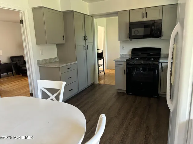 a kitchen with stainless steel appliances a stove a microwave and a refrigerator