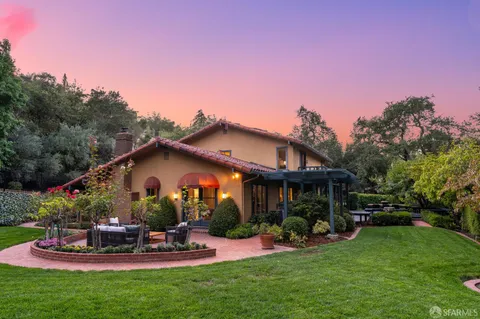 a view of a house with furniture and garden