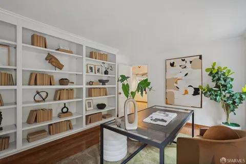 a view of a patio with table and chairs potted plants and a large tree