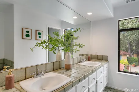 a swimming pool view with a seating space and garden