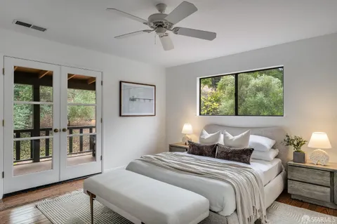 a view of a patio with table and chairs with wooden floor and fence