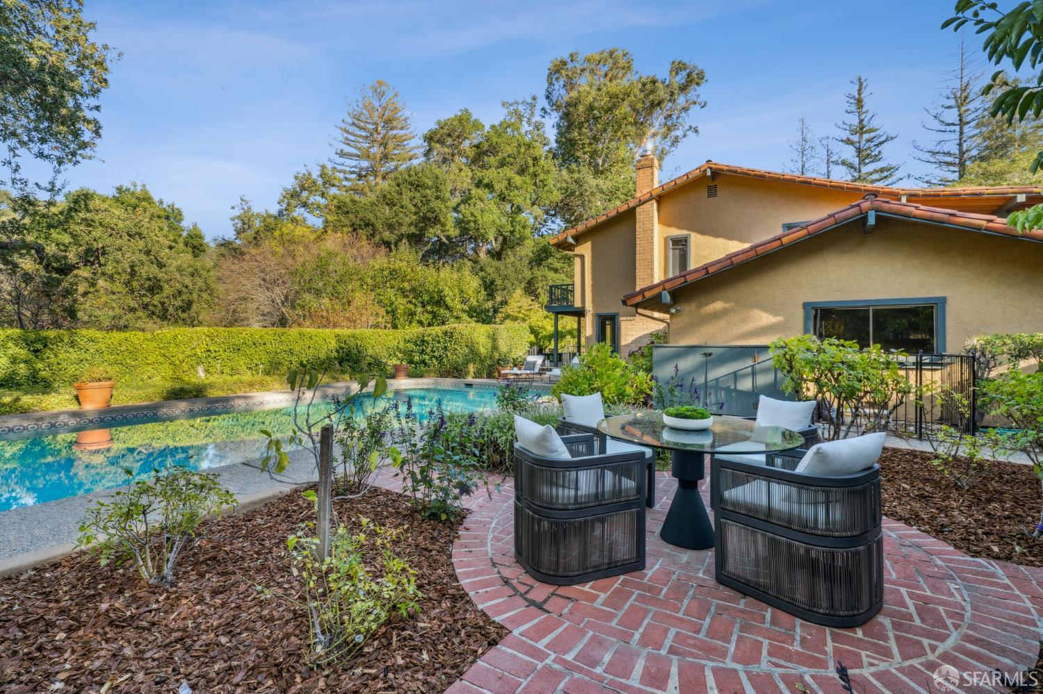 16244 Kennedy Road Los Gatos, CA 95032 - Photo 44 of 67 a view of a patio with table and chairs potted plants and a large tree