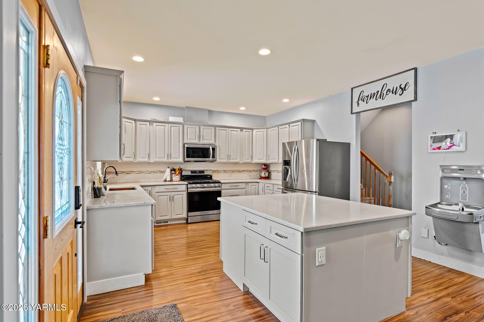 321 Gangl Road Wapato, WA 98951 - Photo 51 of 54 a kitchen with white cabinets and stainless steel appliances