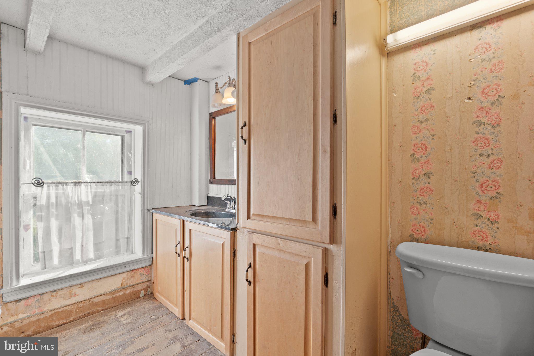 10819 Shanktown Road Big Pool, MD 21711 - Photo 51 of 79 a bathroom with a granite countertop sink and a toilet