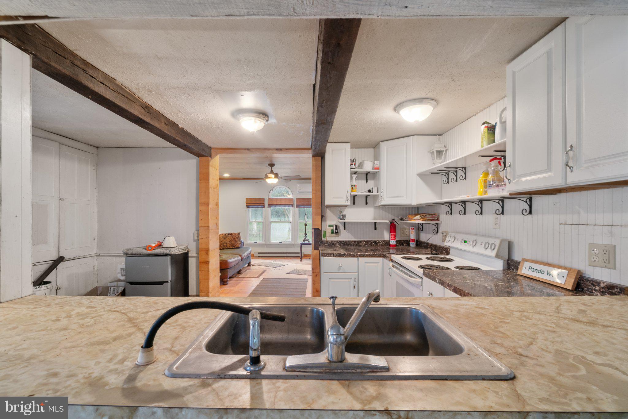 10819 Shanktown Road Big Pool, MD 21711 - Photo 65 of 79 a kitchen with stainless steel appliances granite countertop a sink and white cabinets