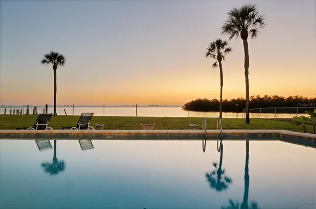 a front view of a house with a garden and yard
