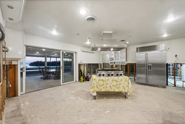 a living room with kitchen furniture and a table