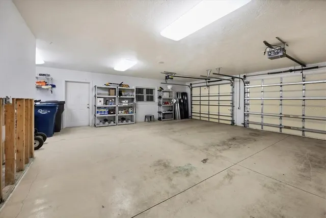 a front view of a house with a garden and trees