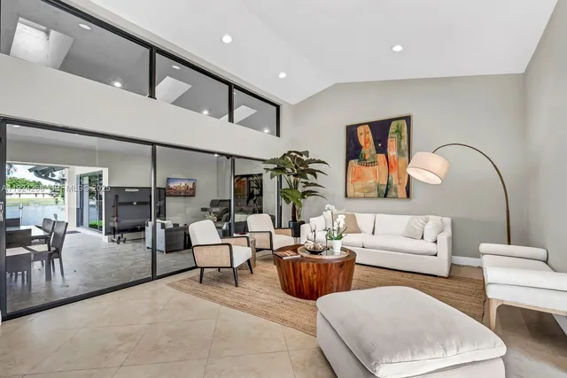 a living room with furniture a rug and white walls