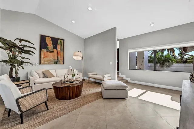 a living room with furniture a lamp and a large window