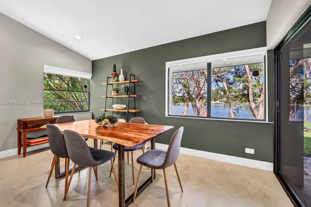 a dining room with furniture and window