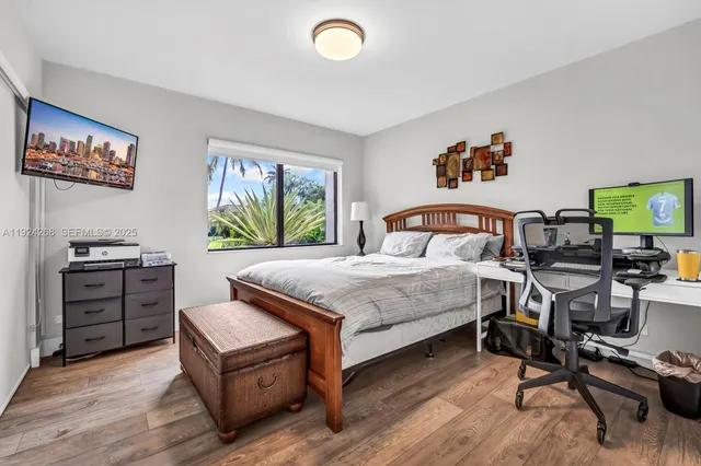 a bedroom with a bed and a desk