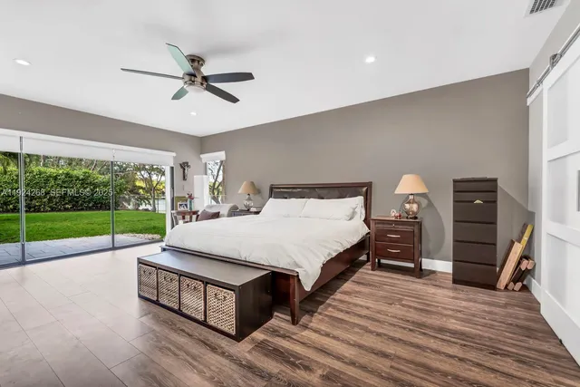 a bed room with a bed and a large window