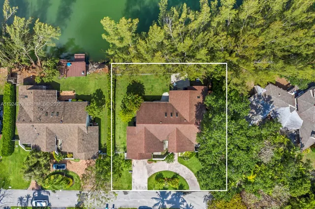 an aerial view of a house with a yard basket ball court and outdoor seating