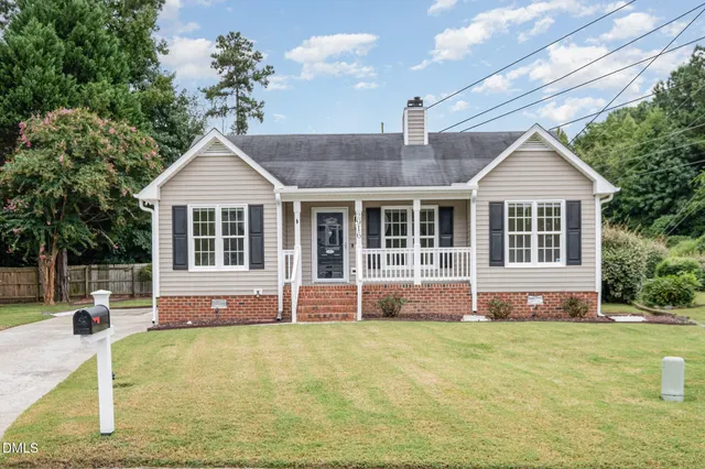 a front view of a house with a garden and porch