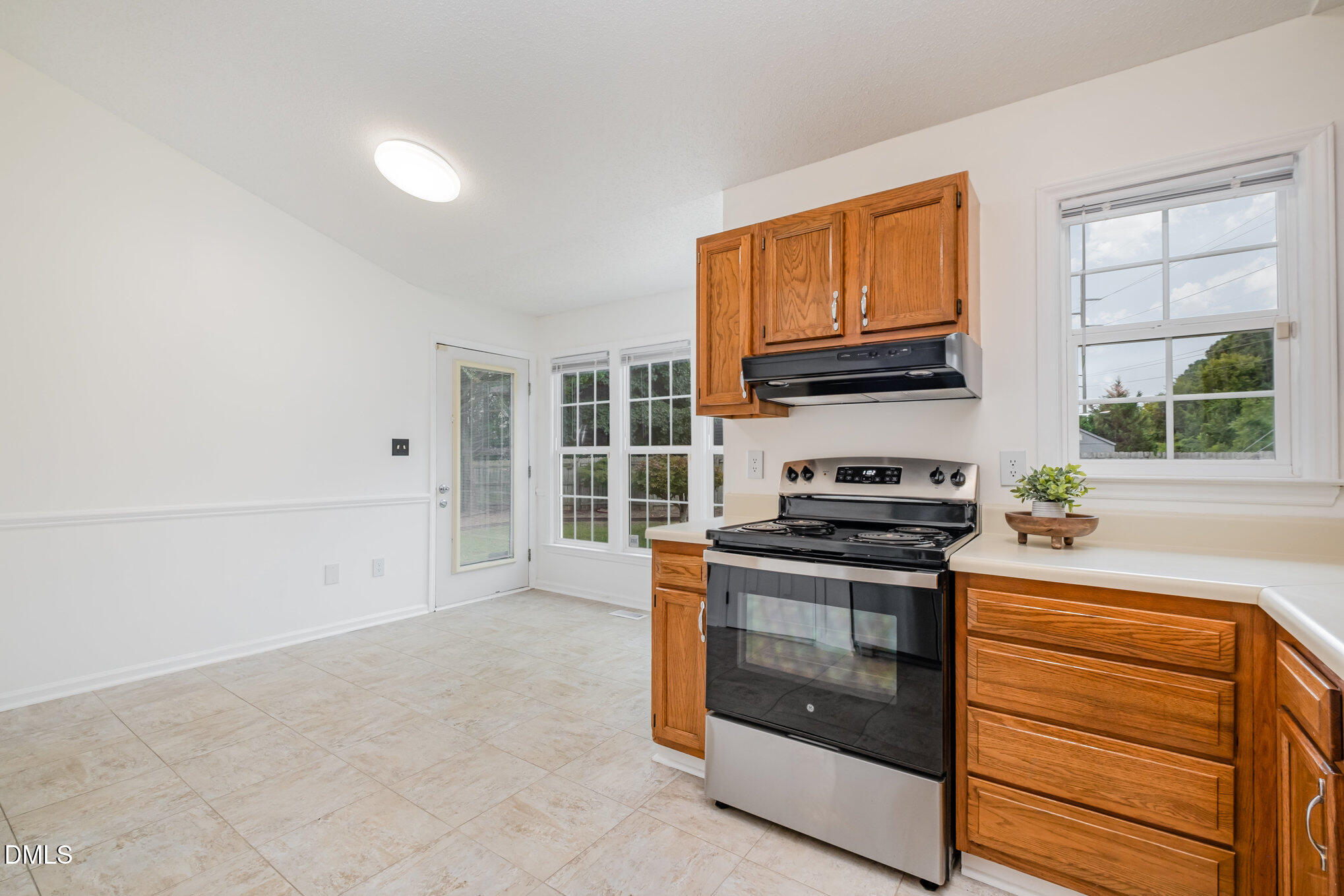 2916 Bannf Court Raleigh, NC 27604 - Photo 12 of 31 a kitchen with stainless steel appliances granite countertop a stove and a microwave