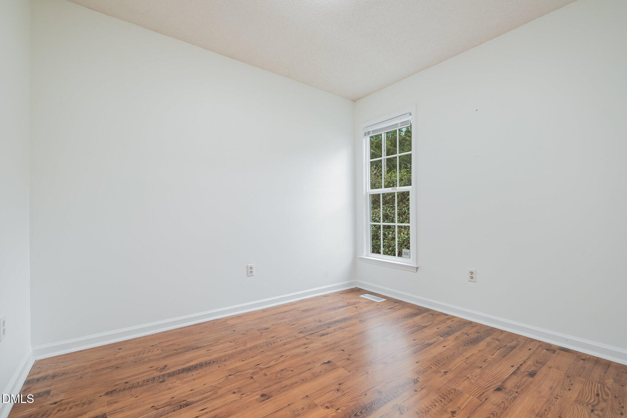 2916 Bannf Court Raleigh, NC 27604 - Photo 20 of 31 an empty room with wooden floor and window