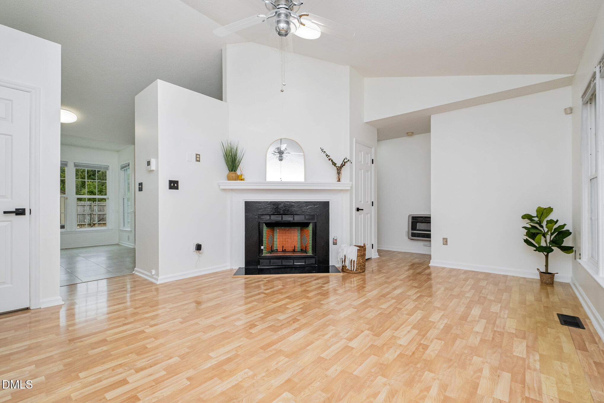 2916 Bannf Court Raleigh, NC 27604 - Photo 2 of 31 a view of an empty room with a fireplace and a window