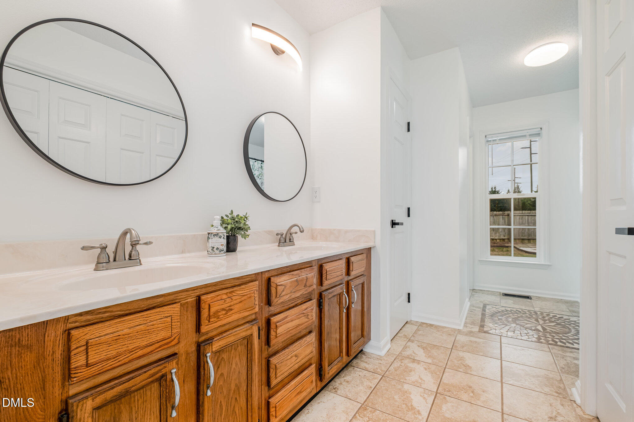 2916 Bannf Court Raleigh, NC 27604 - Photo 6 of 31 a bathroom with a sink and a mirror
