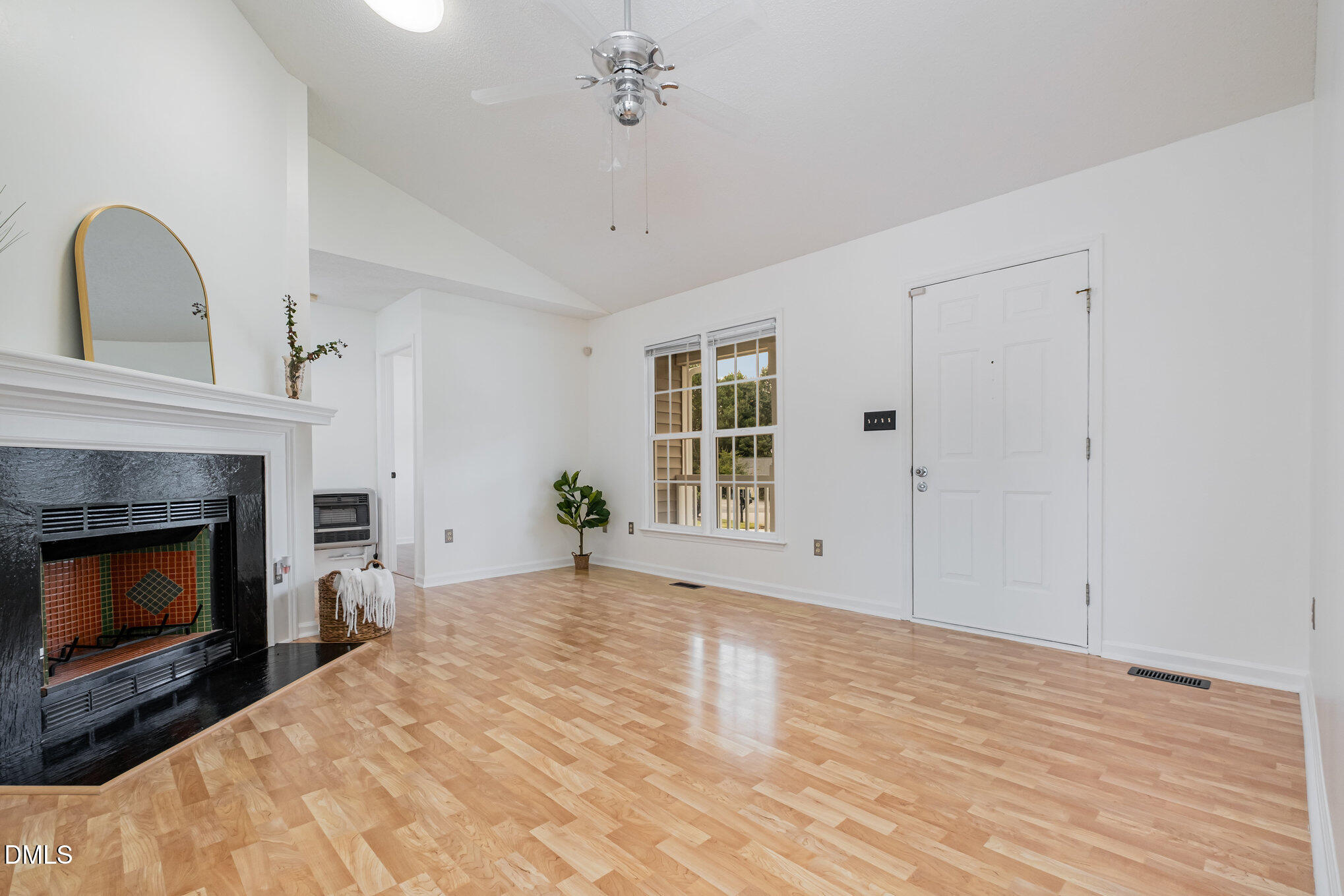 2916 Bannf Court Raleigh, NC 27604 - Photo 7 of 31 a view of an empty room with wooden floor fireplace and a window