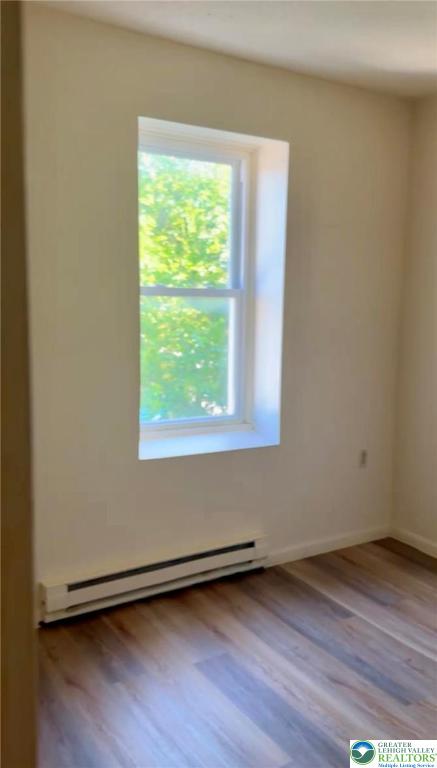 402 Ridge Avenue, Unit 4N Allentown, PA 18102 - Photo 8 of 9 an empty room with wooden floor and windows