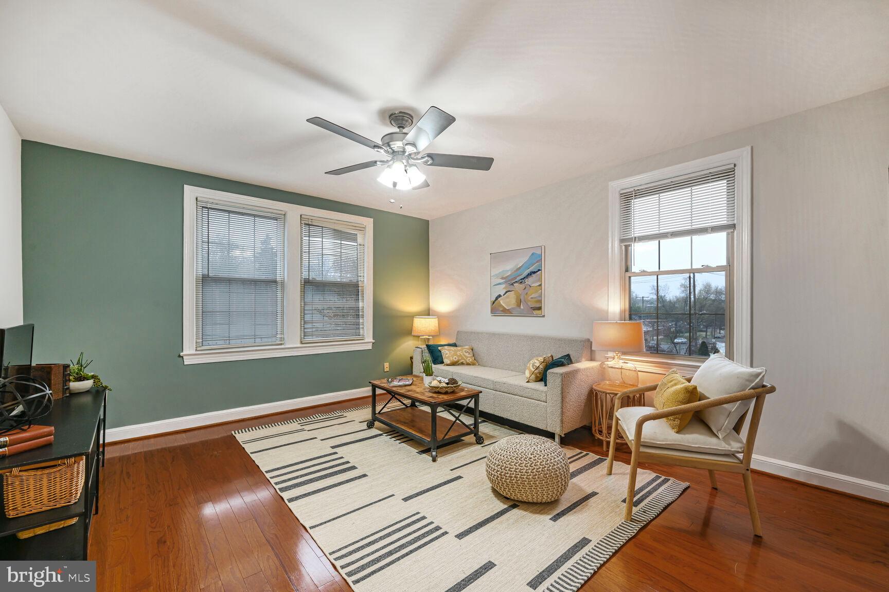 6722 3rd Street Northwest, Unit 203 Washington, DC 20012 - Photo 1 of 18 a living room with furniture two window and a wooden floor