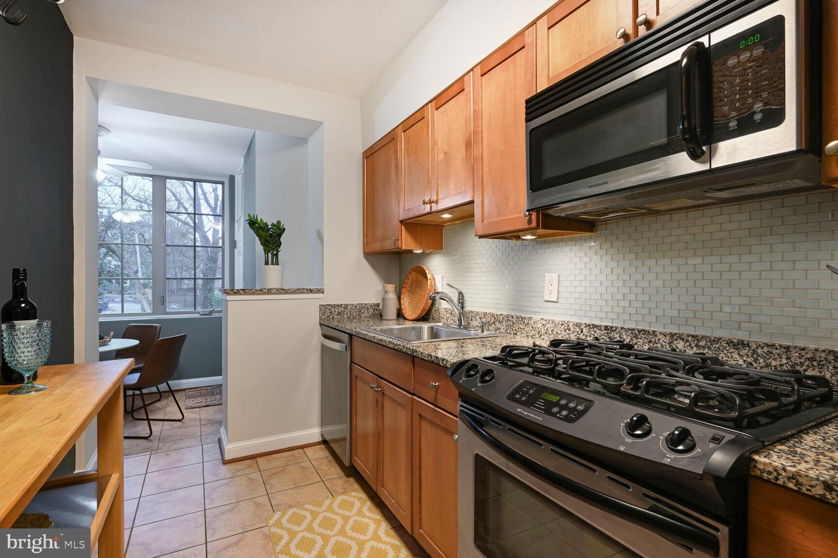 6722 3rd Street Northwest, Unit 203 Washington, DC 20012 - Photo 12 of 18 a kitchen with a stove and a microwave