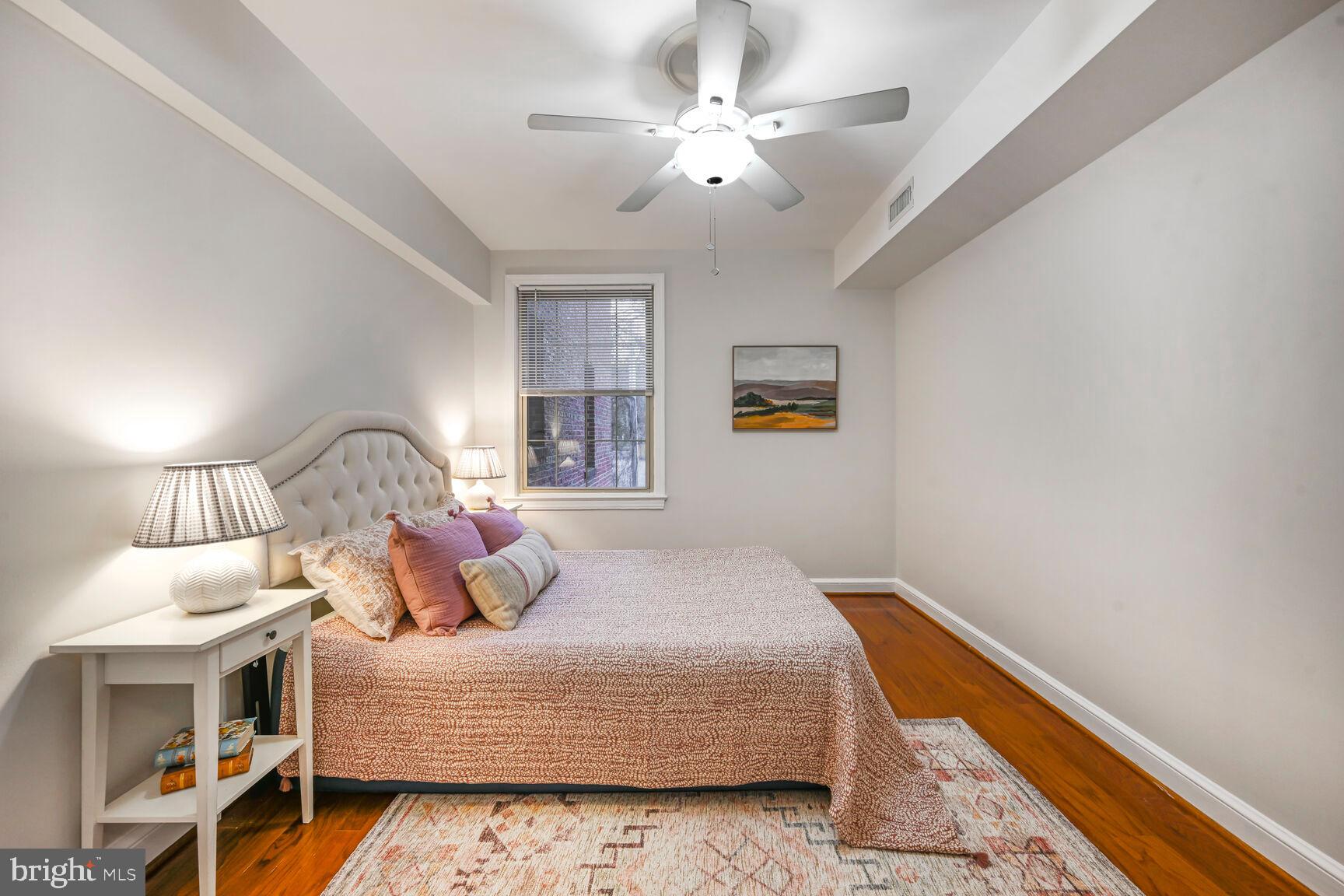 6722 3rd Street Northwest, Unit 203 Washington, DC 20012 - Photo 15 of 18 a bedroom with a bed and a chandelier