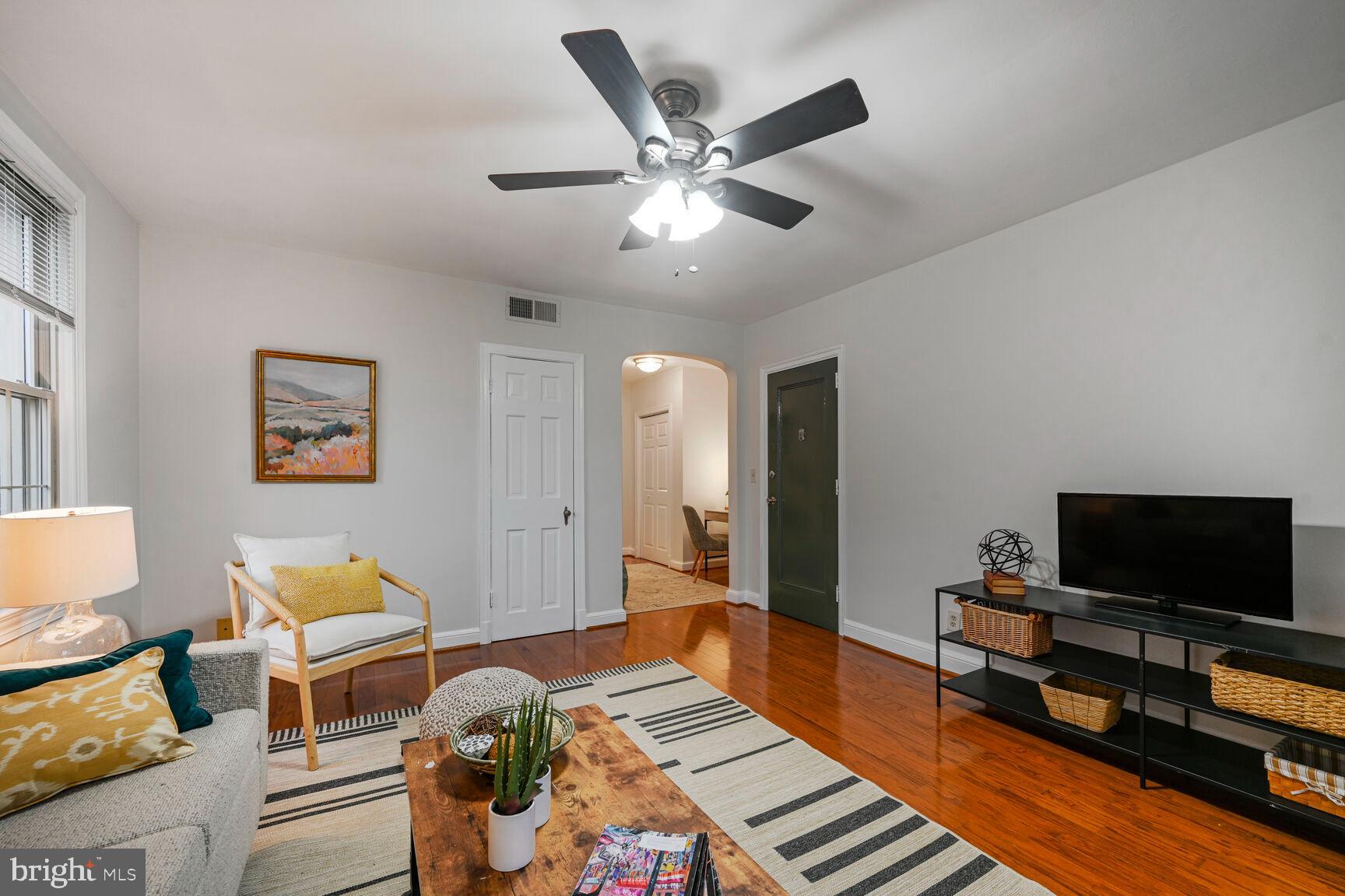 6722 3rd Street Northwest, Unit 203 Washington, DC 20012 - Photo 3 of 18 a living room with furniture and a flat screen tv