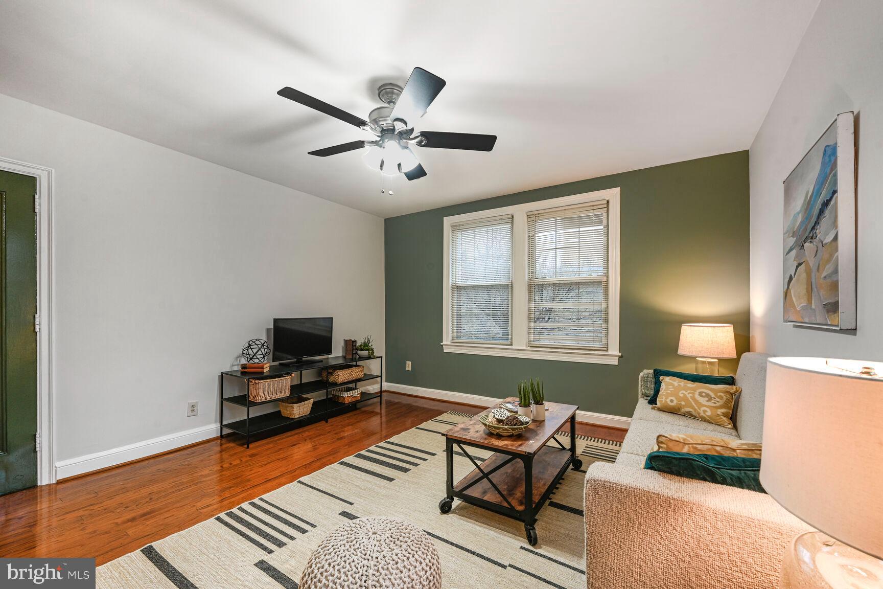 6722 3rd Street Northwest, Unit 203 Washington, DC 20012 - Photo 4 of 18 a living room with furniture and a flat screen tv