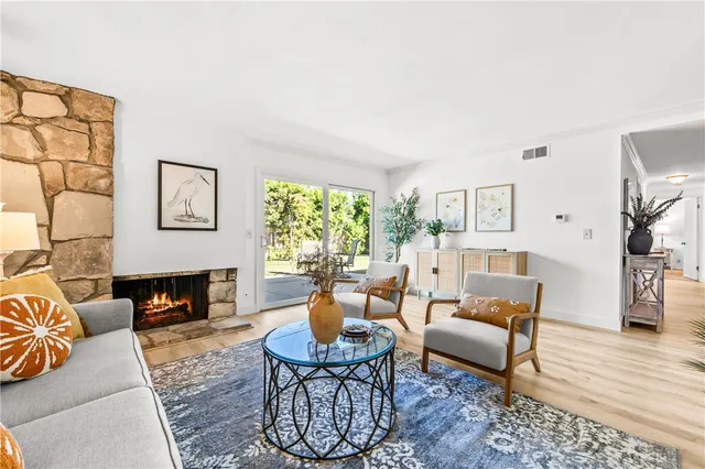a living room with furniture fireplace and a table