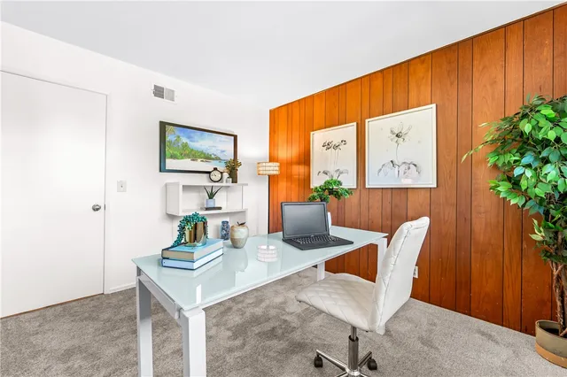a view of a dining room with furniture and a potted plant
