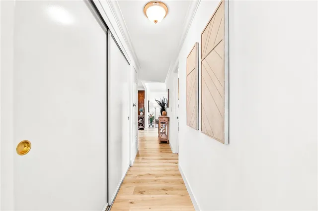 a view of a hallway with wooden floor and stairs