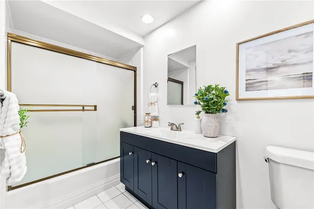 a bathroom with a sink mirror and vanity
