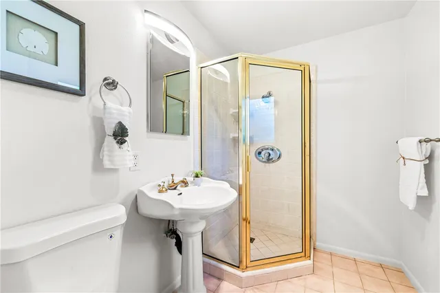 a bathroom with a toilet a sink and a mirror