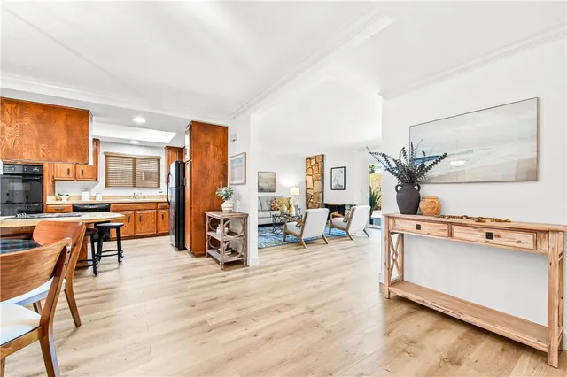 a living room with furniture and large mirror next to a window