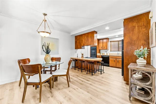 a dining room with a table chairs and a kitchen view